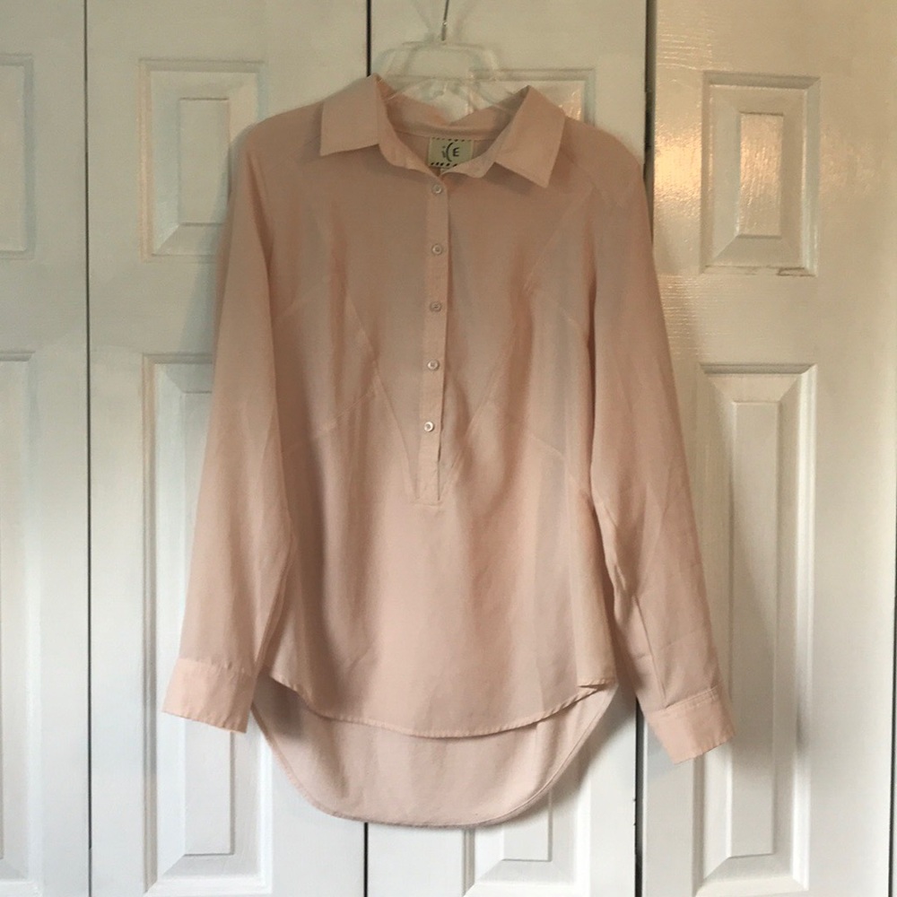 A soft pink button up blouse